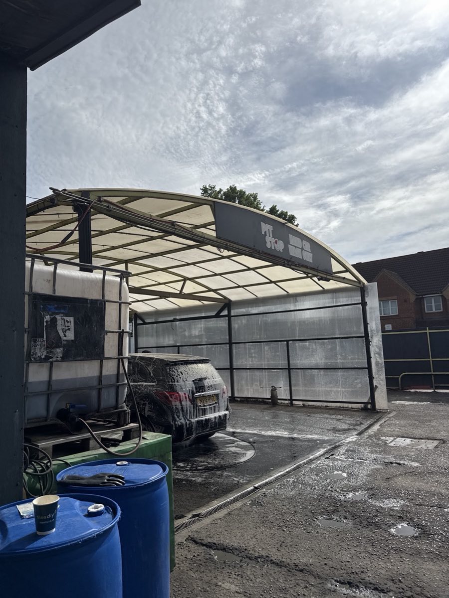 A car covered in snow-foam under the Pit Stop Hand Car Wash covered bay on Ley Street, Newbury Park.