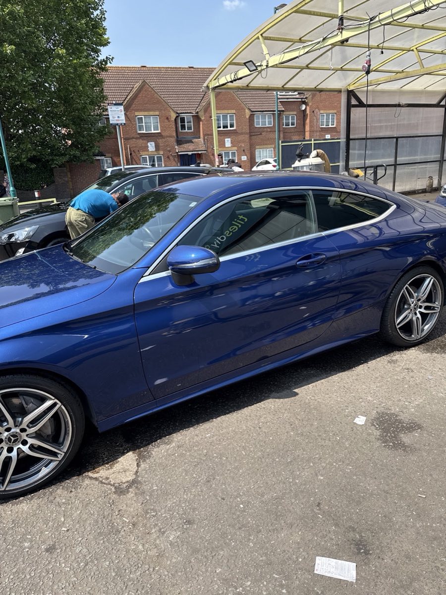 A gleaming blue Mercedes coupe with AMG alloy wheels, freshly hand washed and dried at Pit Stop Hand Car Wash.
